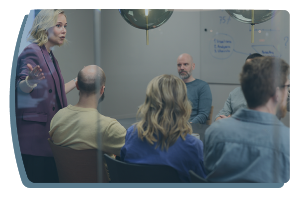 Ett foto över flera medarbetare i ett konferensrum som arbetar i workshop